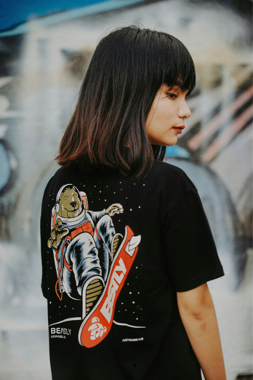 Mujer modelando playera negra estampada.